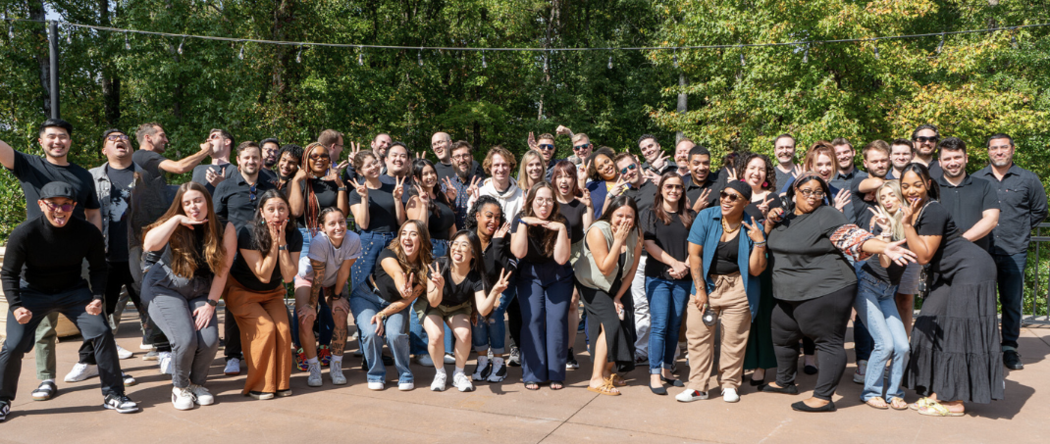 Employees posing for a group photo at an offsite retreat.