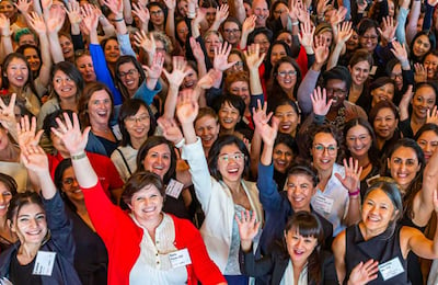 crowd of people with their hands in the air