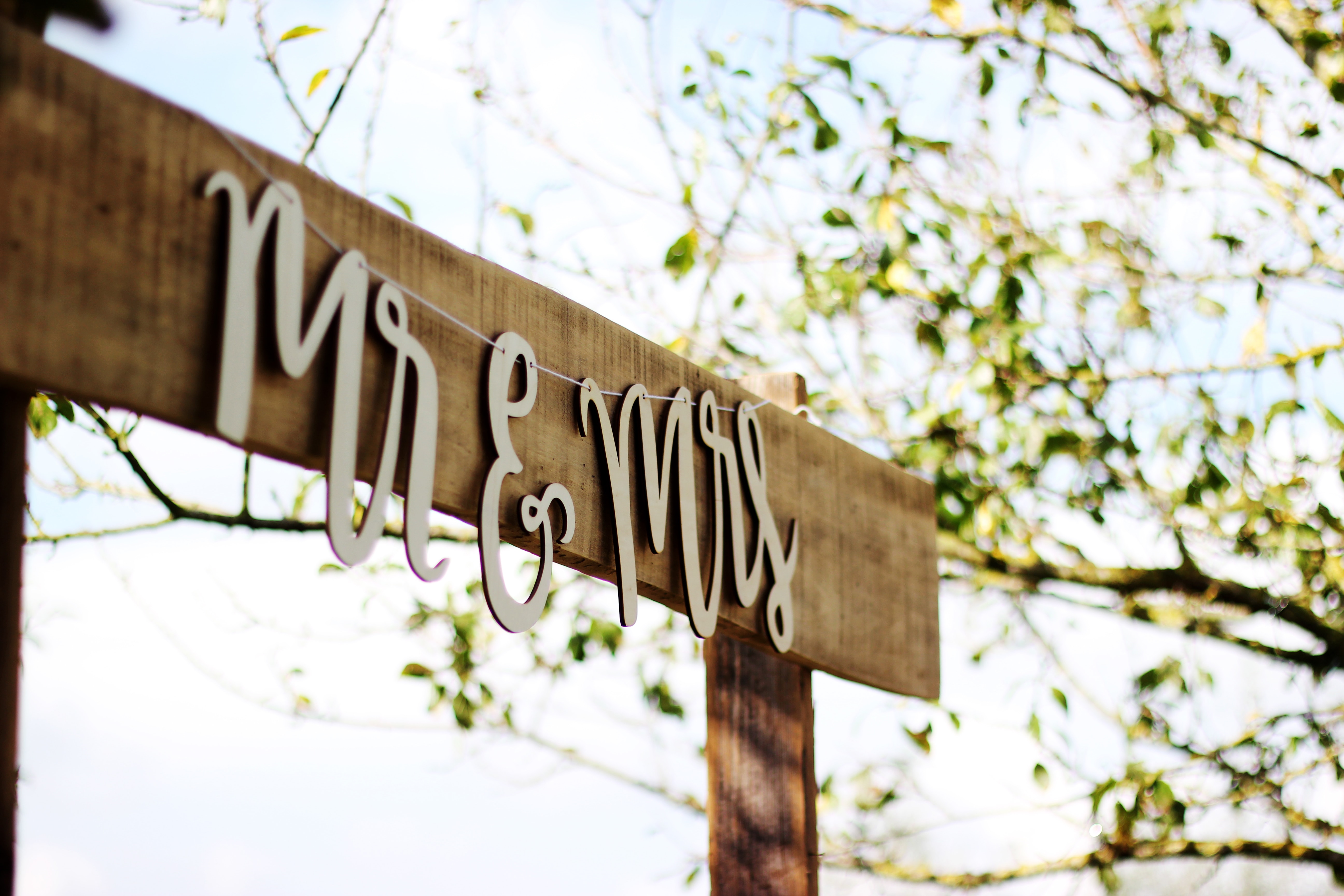 A wooden sign with Mr & Mrs written in cursive.